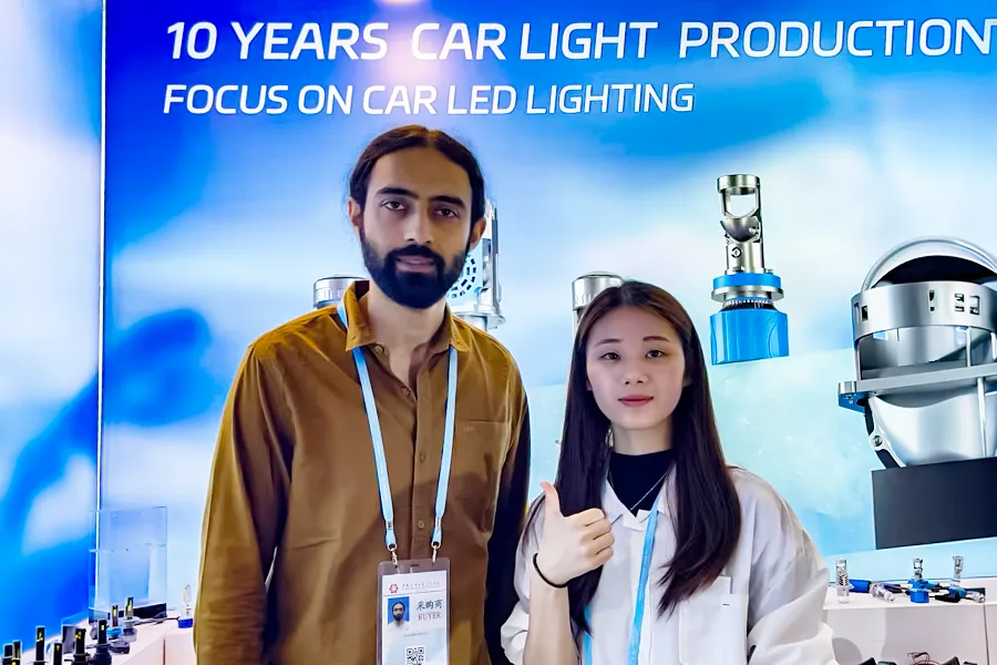 B2B partnership meeting and handshake at a global automotive lighting trade fair